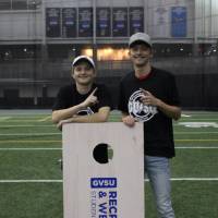 Students wearing championship shirts from a cornhole tournament for Tuesday